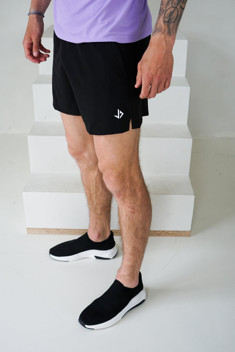 man draagt sportbroek heren zwart met ritszakken