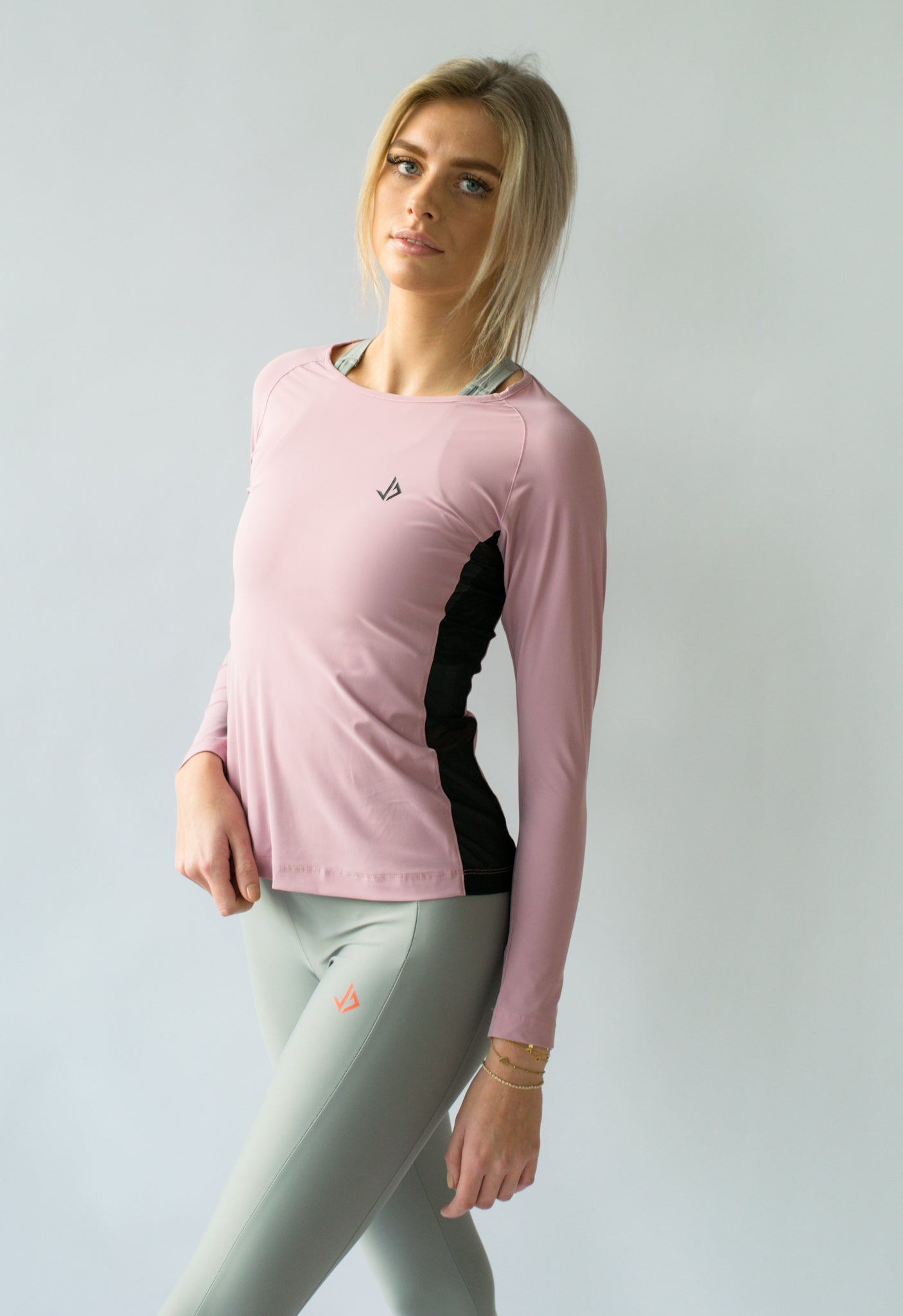 Lange vrouw draagt lila sport longsleeve met extra lange mouwen van JUSS7